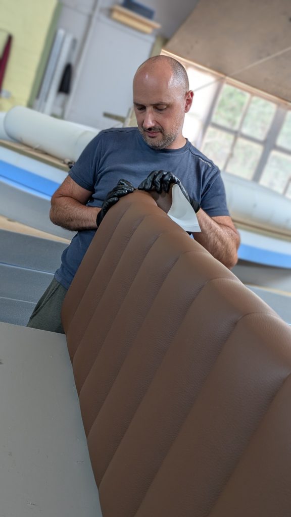 I&M Upholstery craftsman working on leather upholstery in Surrey